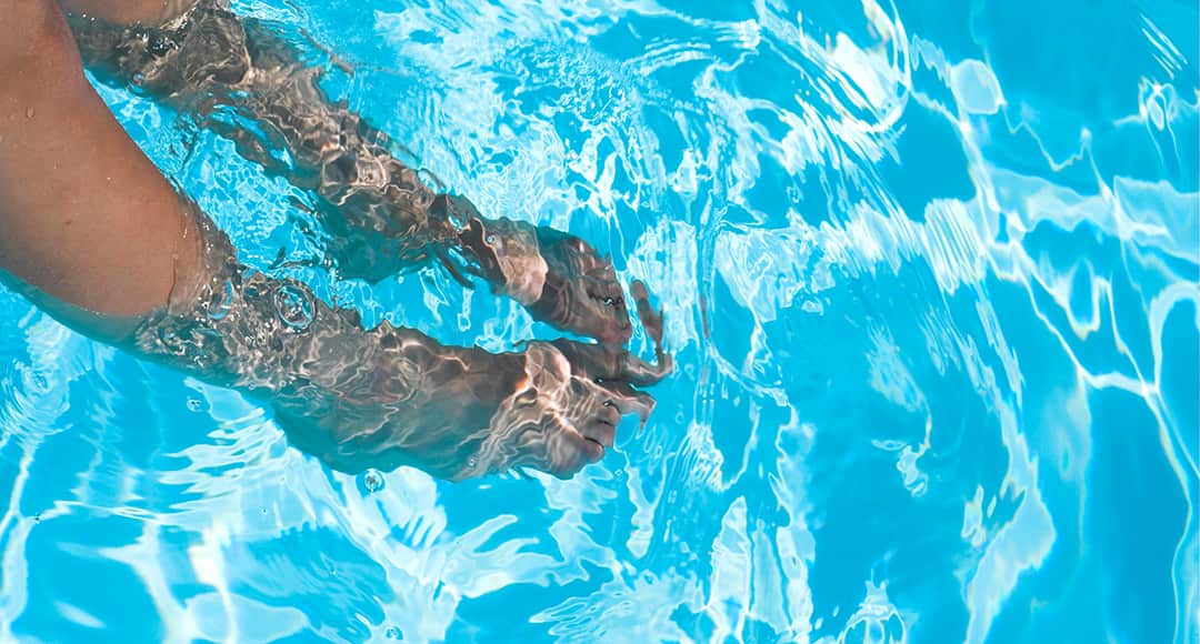 photo of woman feet in pool
