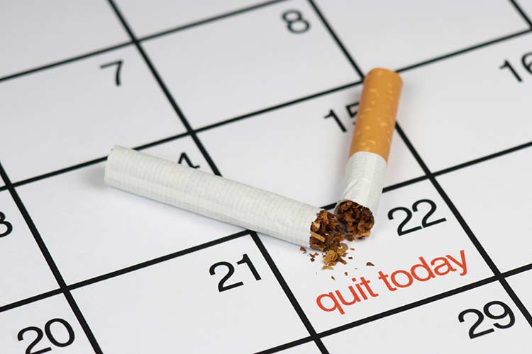 Image of calendar with quit smoking date highlighted and a broken cigarette