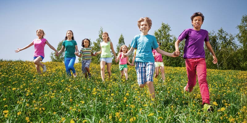 Image of children running and playing on a sunny day