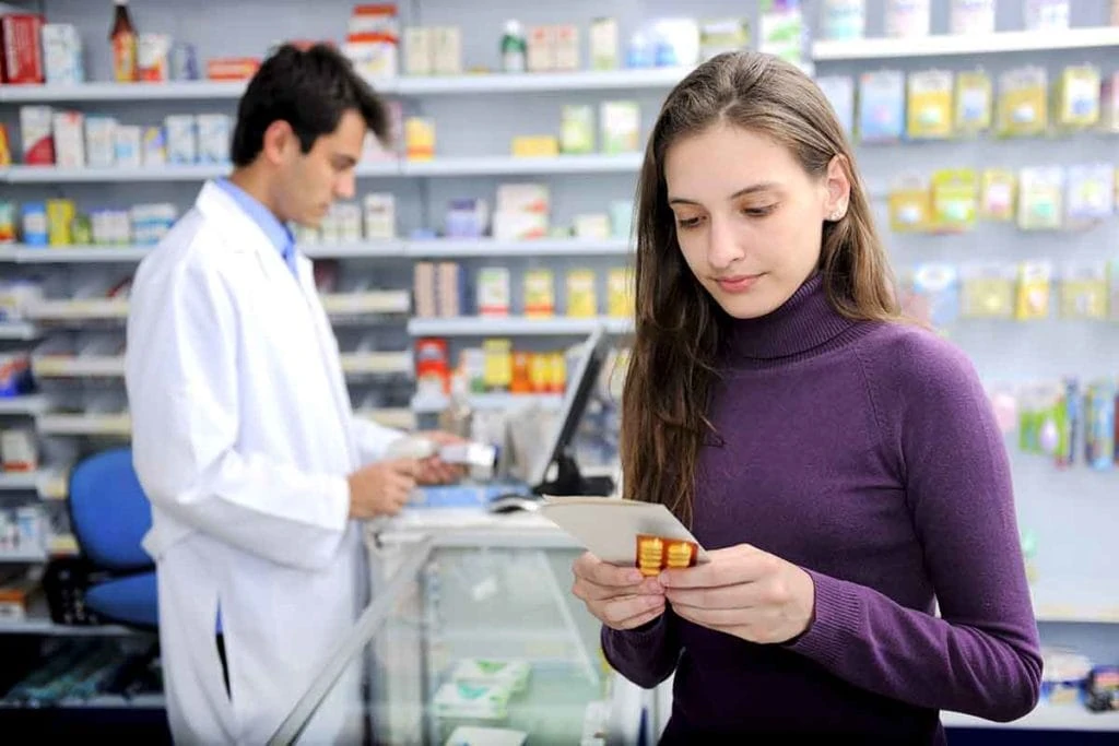 Photo of Woman checking medication at the pharmacy